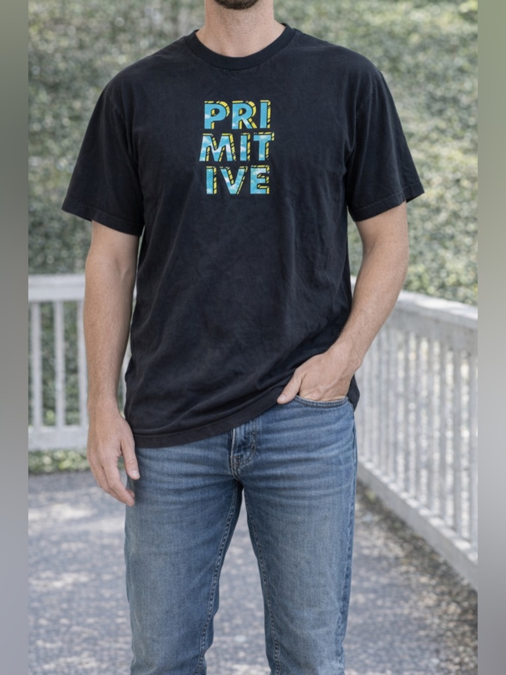 Primitive Black Tee with Blue and Yellow Block Logo